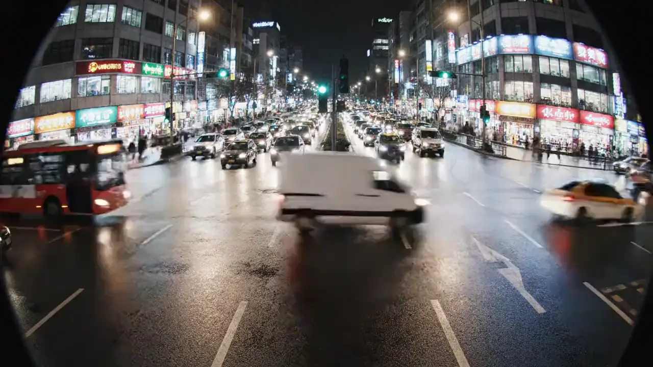 Wide-angle night junction on a live road camera, the view a round opens on